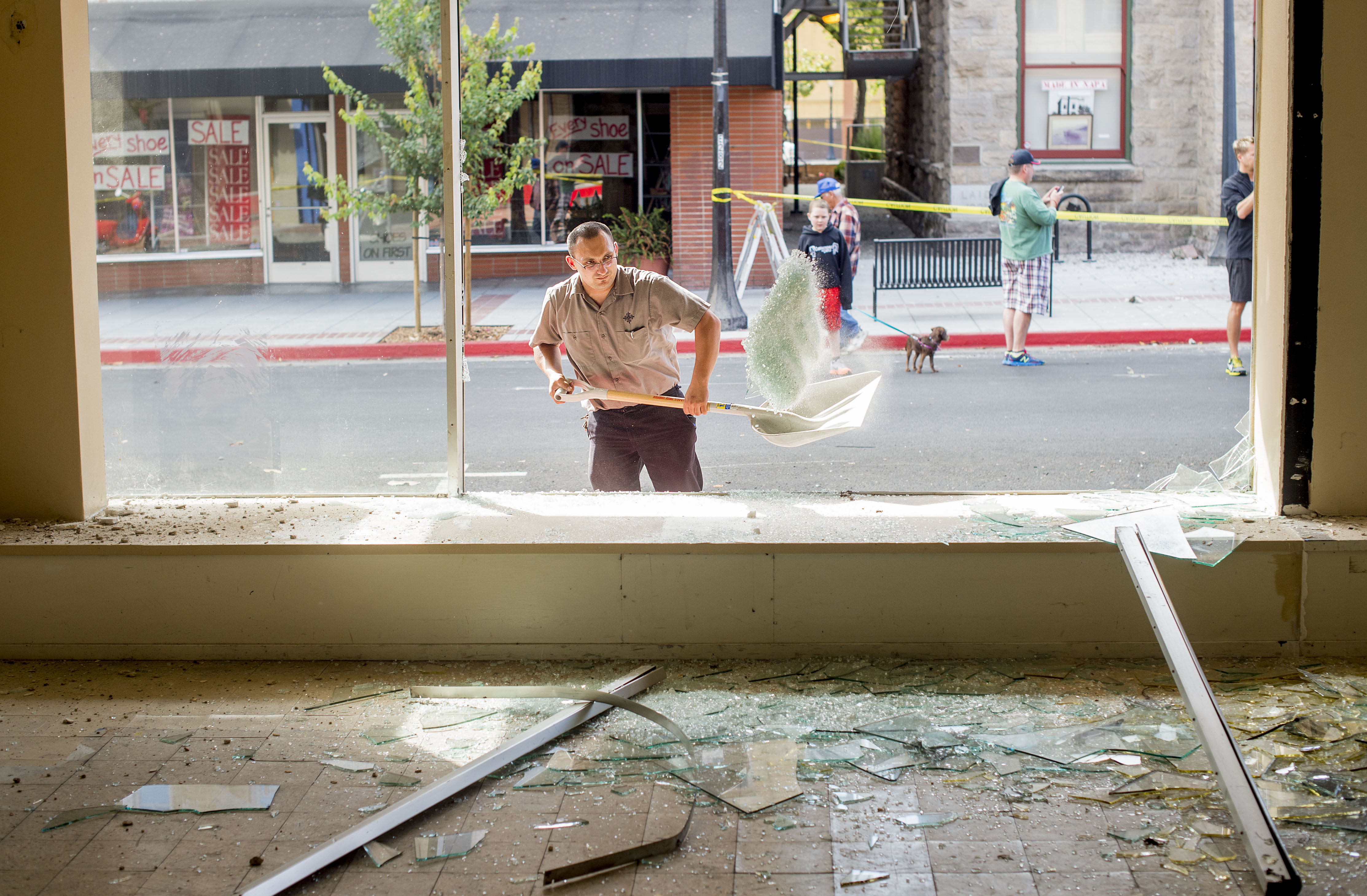 Man cleaning up broken glass