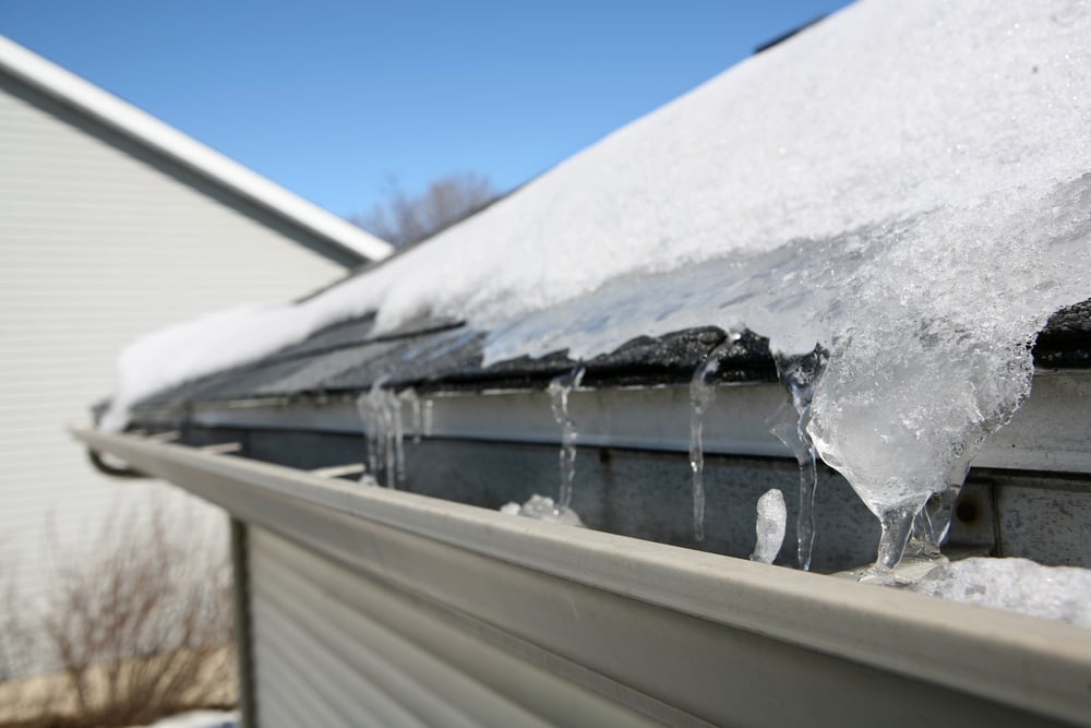 Ice dam in gutter of house