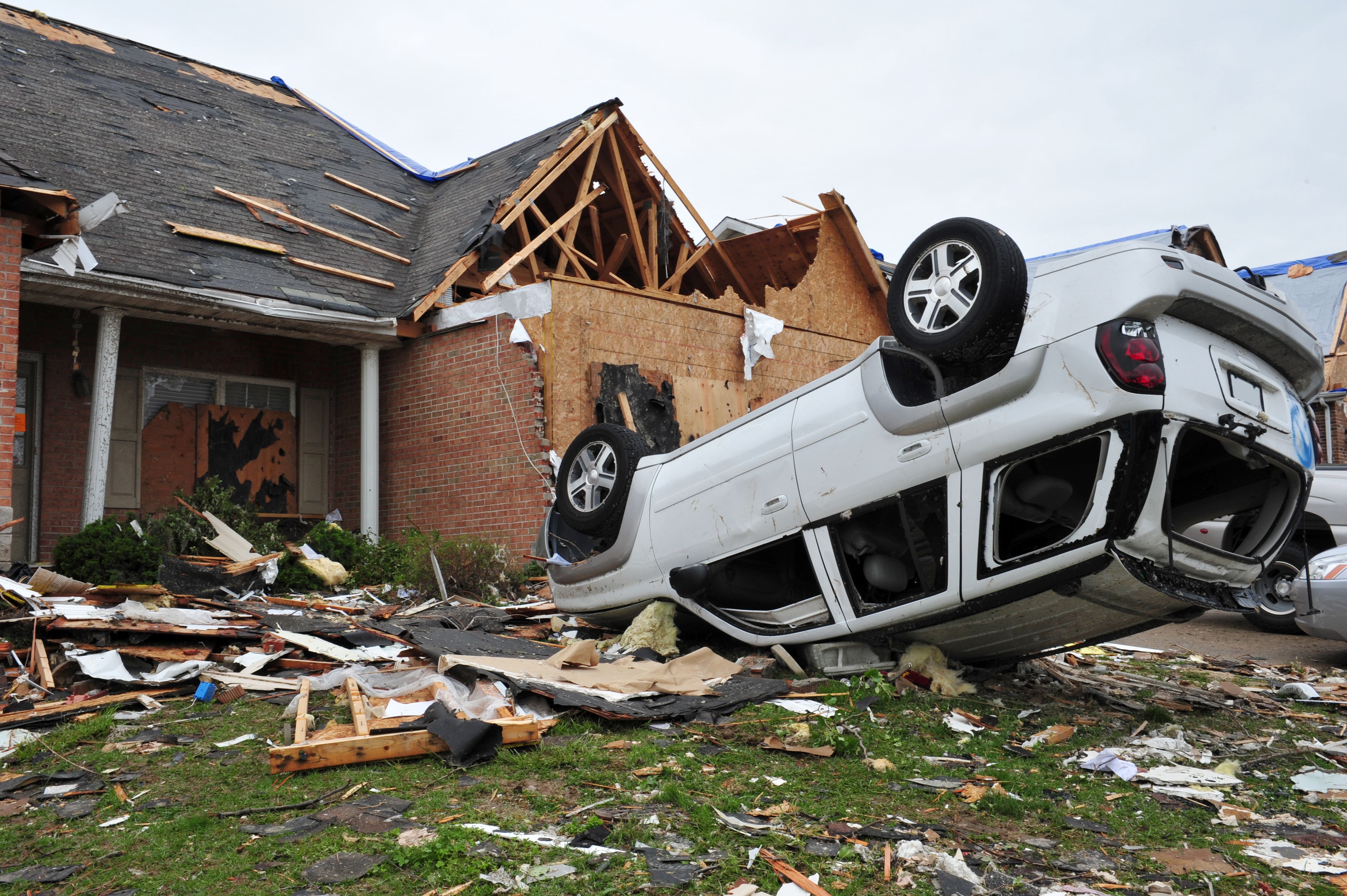 cars and homes heavily damaged by a tornado