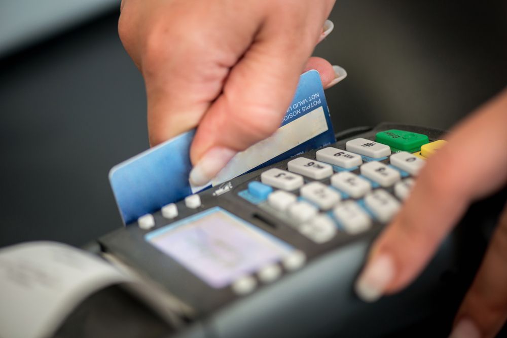 debit card being swiped in card reader