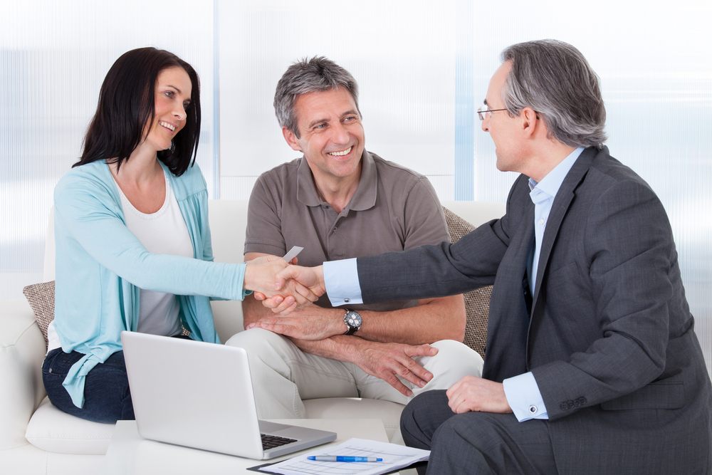 insurance agent shaking hands with a female client