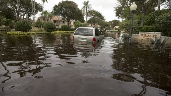 Flood waters filled the streets in the Meadows section of Boynton Beach, Fla., Friday, Jan. 10, 2014, trapping cars. Boynton Beach got nearly two feet of rain in a 24-hour period. (AP Photo/J Pat Carter)