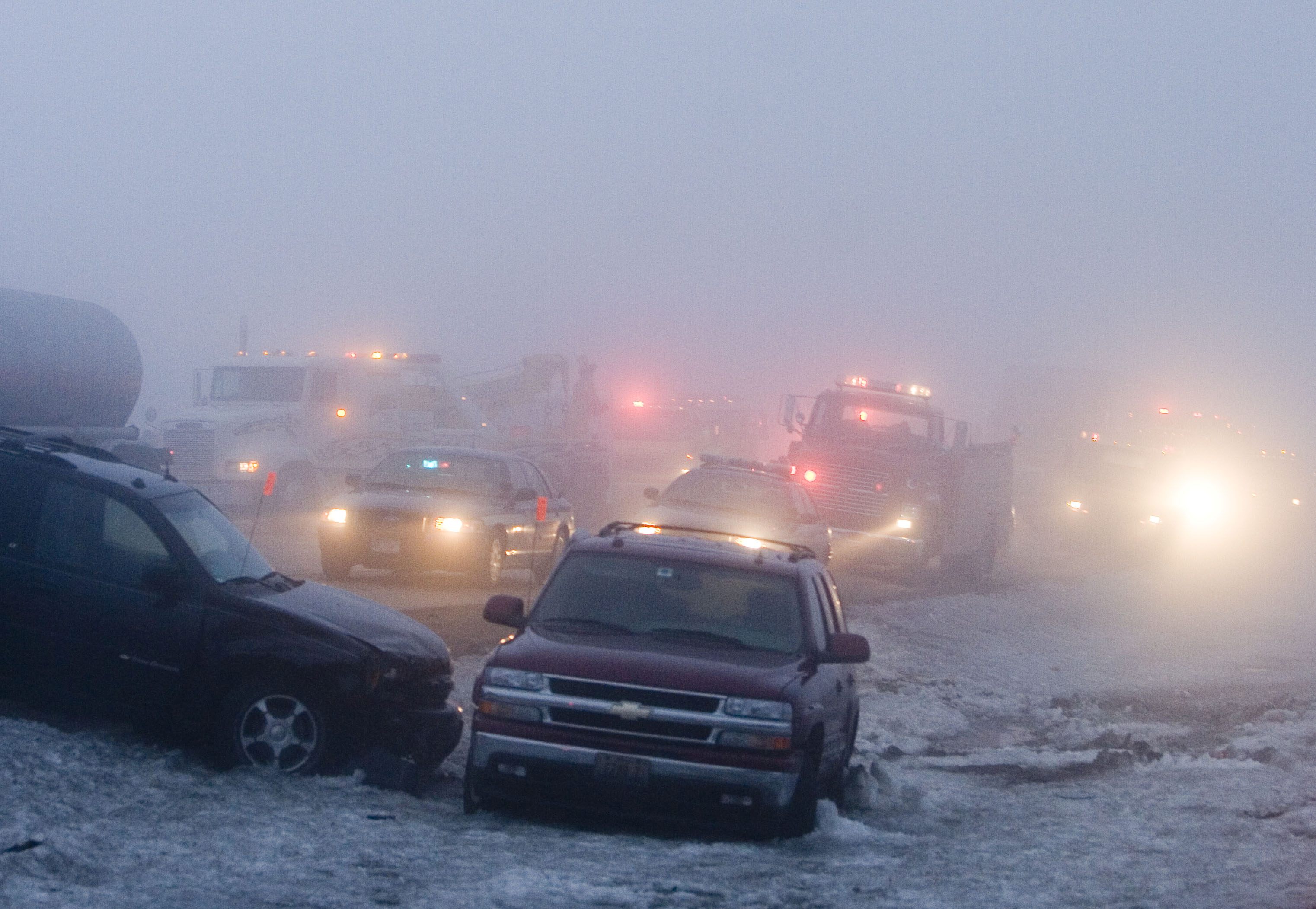 Emergency personnel make their way to multi-car pileup on Interstate 90 near Madison, Wis., Sunday, Jan. 6, 2008. 