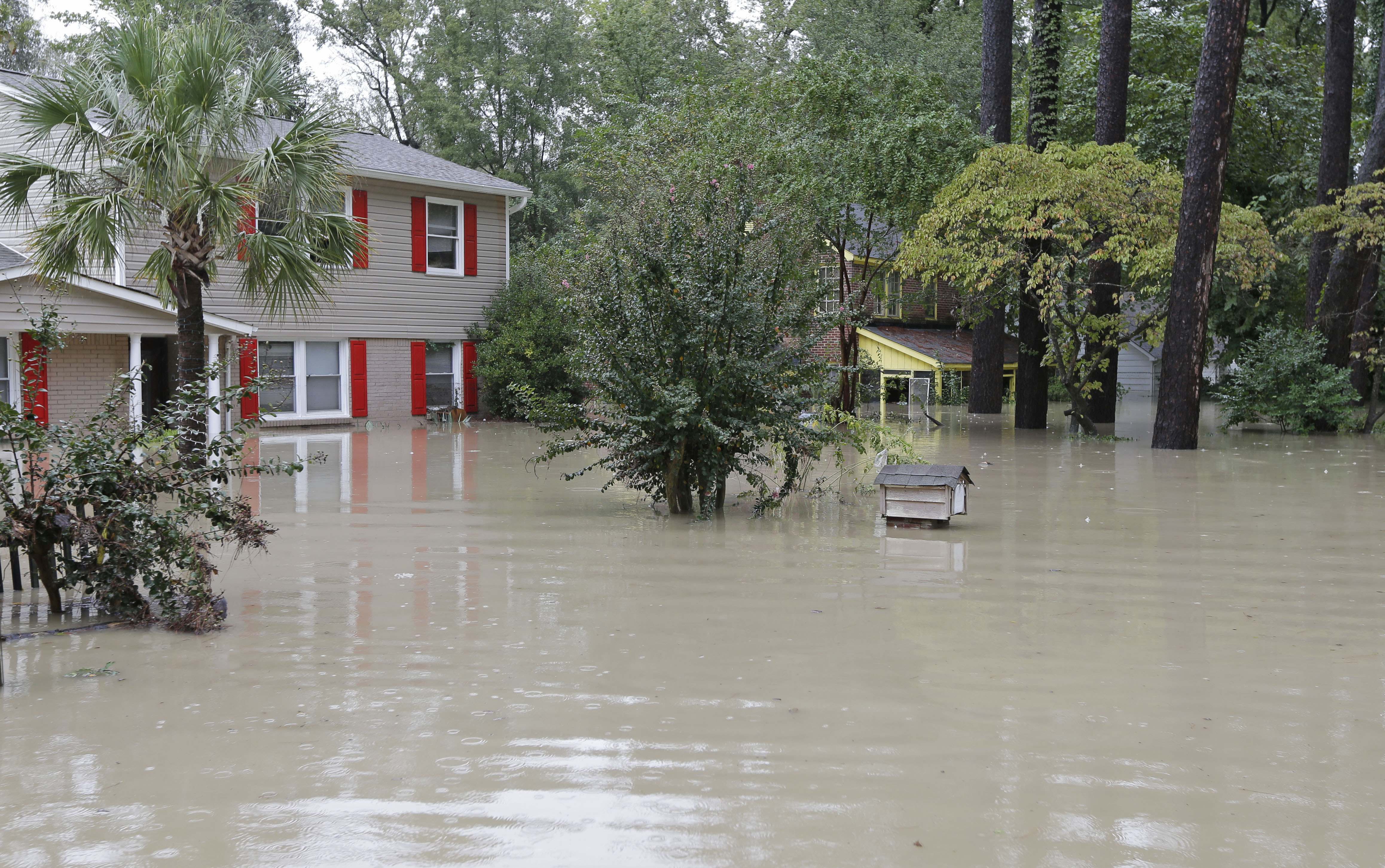 Flood waters climb up the walls of homes in Columbia, S.C., Sunday, Oct. 4, 2015.