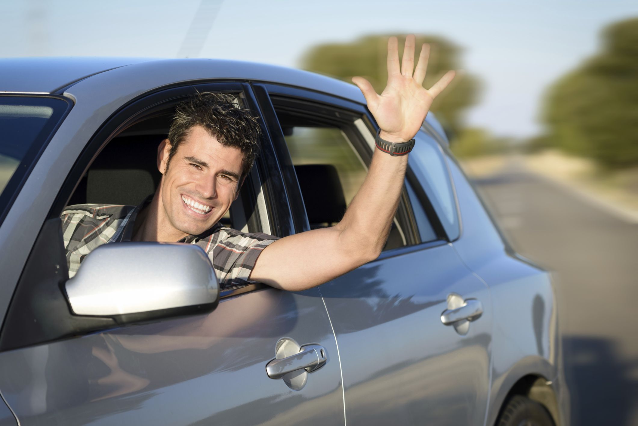 happy man waving from car
