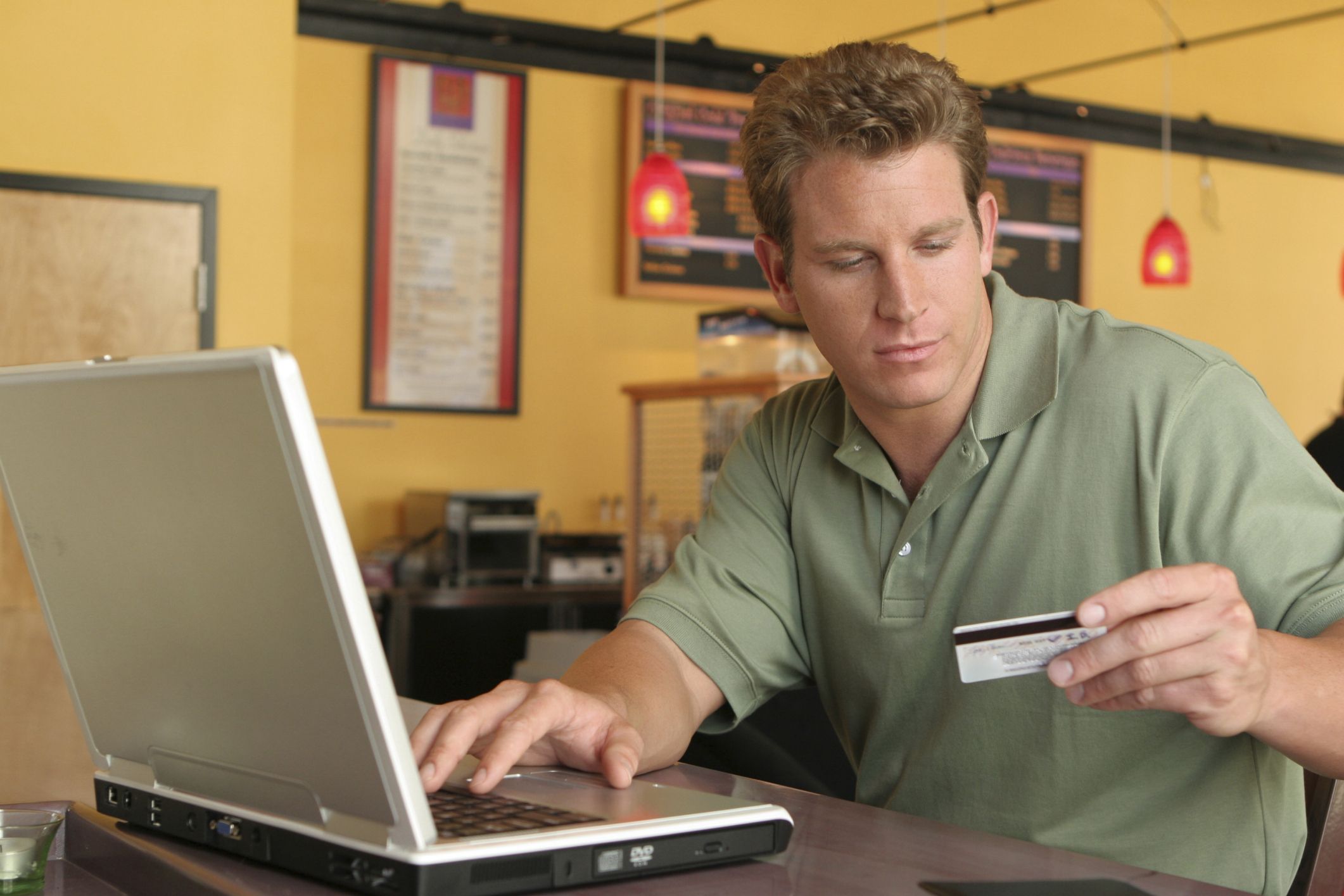 man using credit card to buy small business insurance online