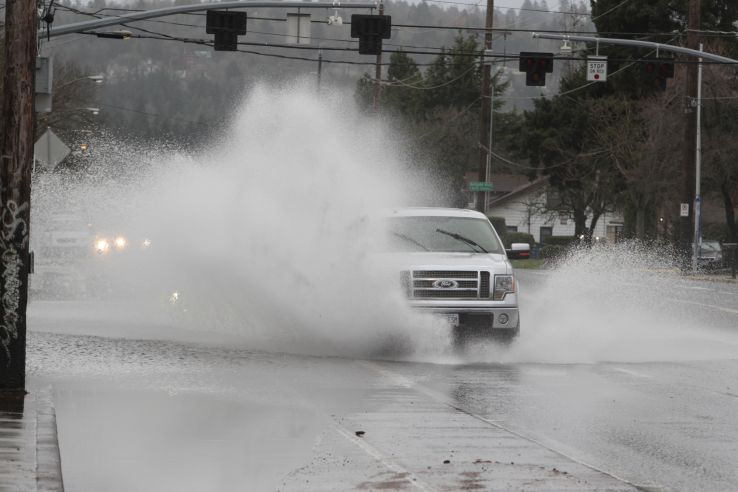Drivers drive through high water in Portland, Ore.