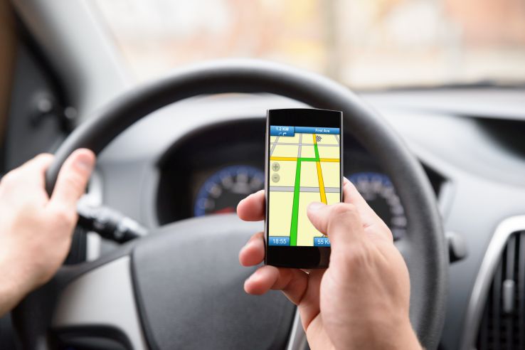 driver looking at GPS on smartphone