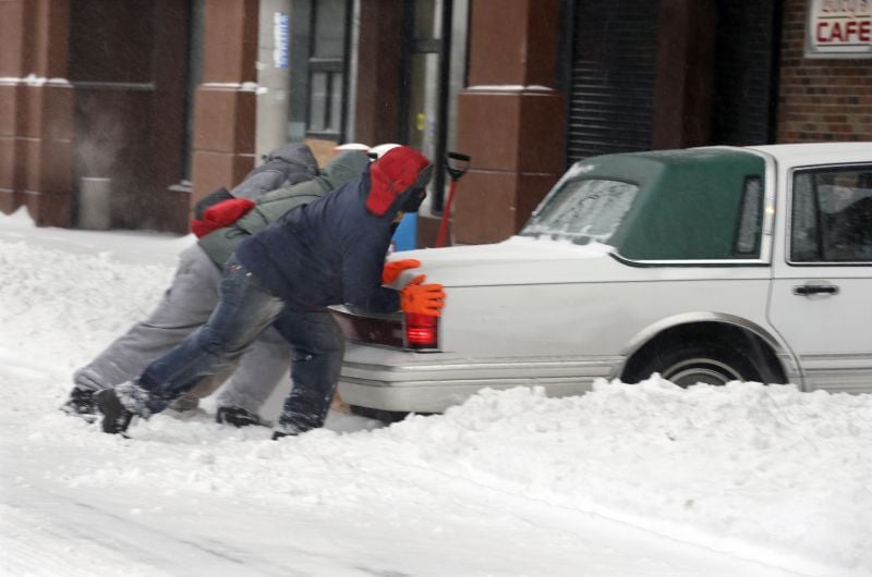 Good samaritans try to push a car stuck in the snow in Trenton, N.J.
