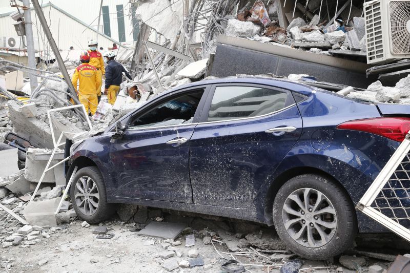 Rescue workers search a collapsed building 