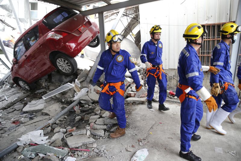 Rescue workers search a collapsed building