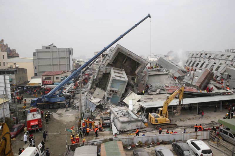 Rescue workers search a collapsed building