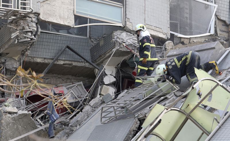 Emergency rescue teams search for victims in a collapsed building 