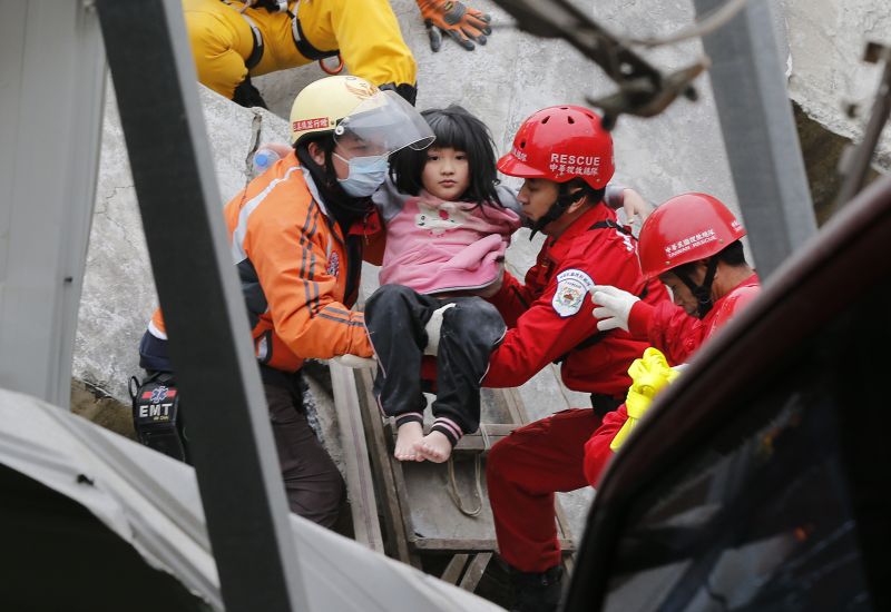 A young girl is rescued from a collapsed building