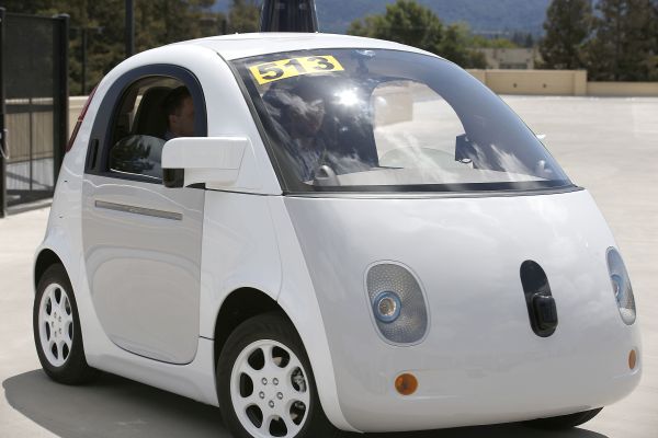 Self-driving white Google car
