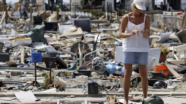 This Sept. 24, 2008, file photo shows Donna Hanson as she pauses to look at an item recovered from debris left where her home once stood in the aftermath of Hurricane Ike in Galveston, Texas. (Photo: David J. Phillip/AP Photo)