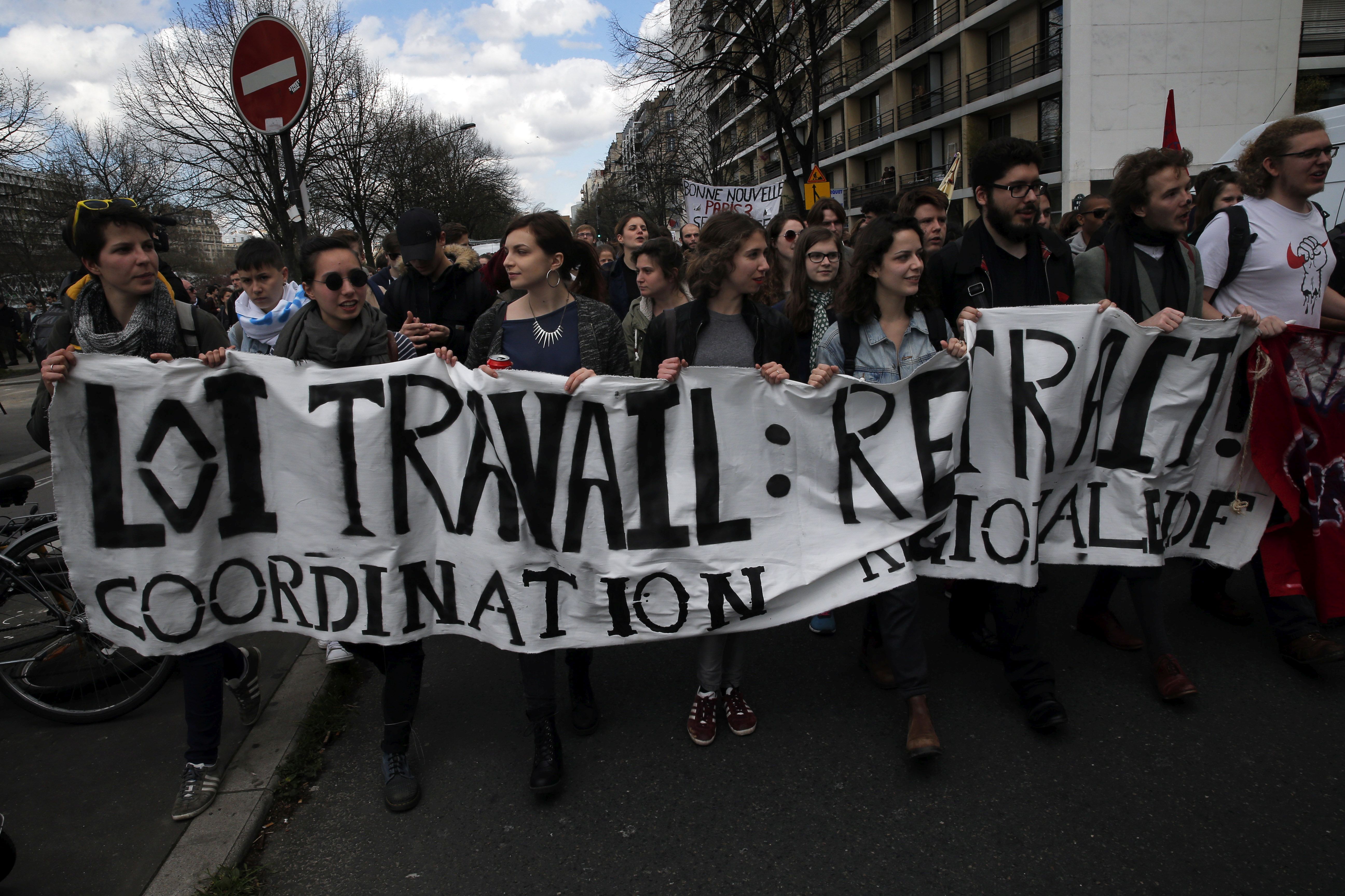 Youth march during a protest against proposed changes to France's work week and layoff practices