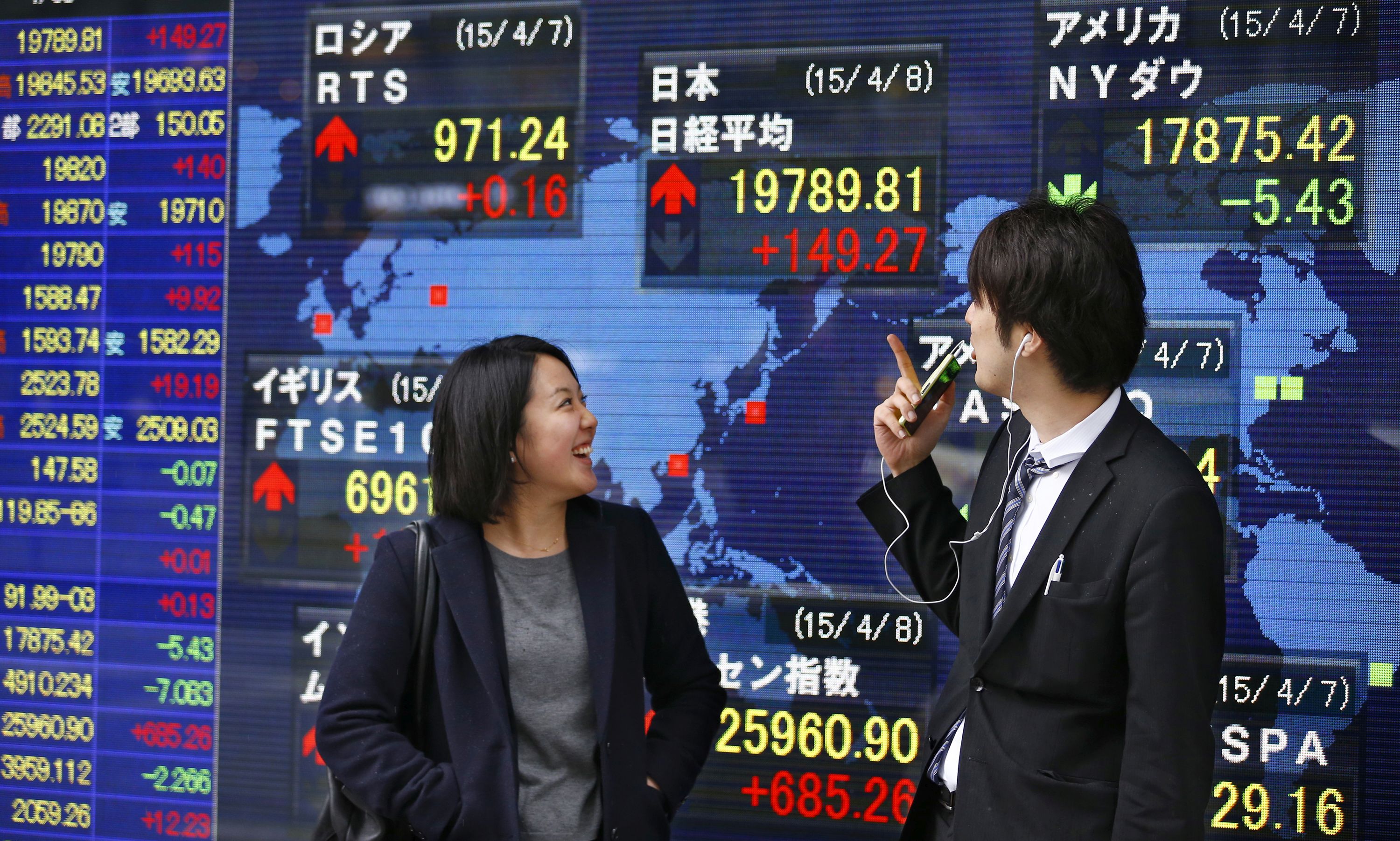 People check an electronic stock indicator of a securities firm in Tokyo 