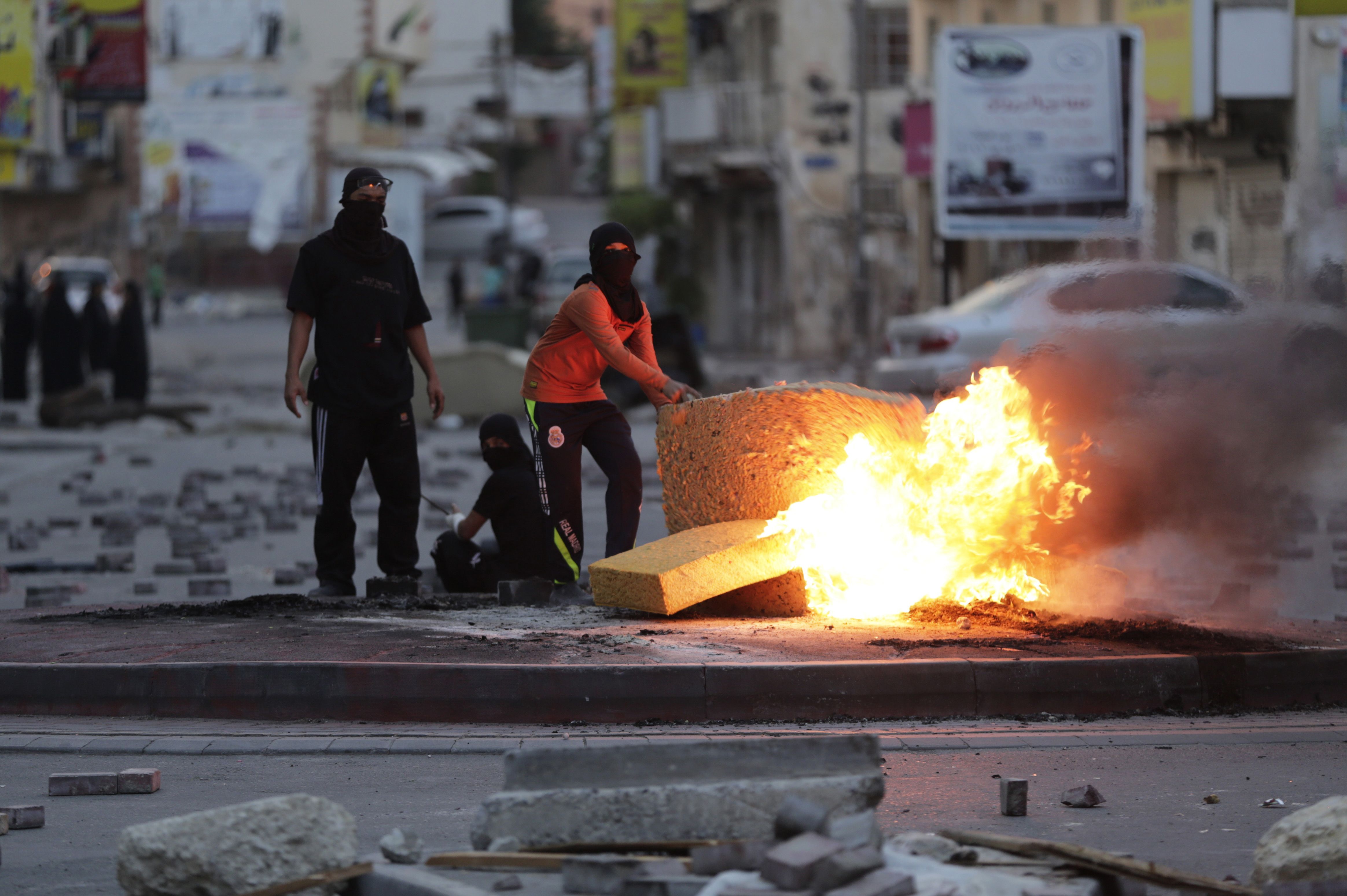 Bahraini anti-government protesters burn old furniture during clashes with riot police