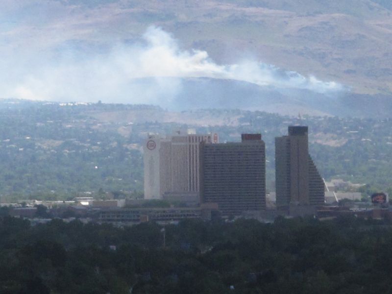 Smoke from a wind-driven brush fire on the southwest edge of Reno, Nev.