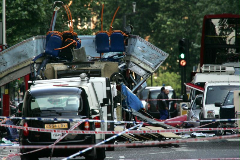 Wreckage of a double-decker bus with its top blown off 