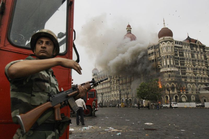 ndian soldier takes cover as the Taj Mahal hotel burns 