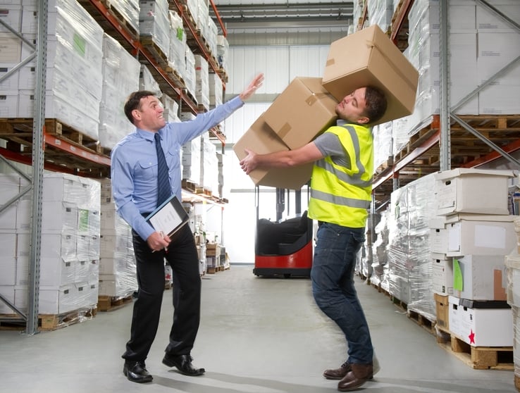 Man dropping boxes in warehouse