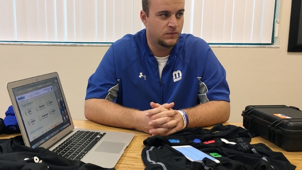 In this March 20, 2016, photo, Ben Hansen, chief technology officer of Motus Global, explains how five sensors placed in compression clothing measure crucial baseball player data, such as hip speed or torque on the elbow, in Bradenton, Fla. According to the Associated Press, Major League Baseball's playing rules committee approved two devices for use during games this season. Similar devices could help other workers who lift and twist on the job. (AP Photo/Tamara Lush, File)