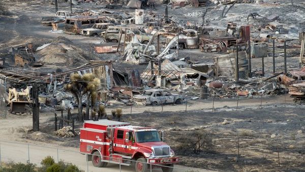 A firetruck passes scorched cars and trailers burned by the Blue Cut fire in Phelan, Calif., on Friday, Aug. 19. (Photo: Noah Berger/AP Photo)