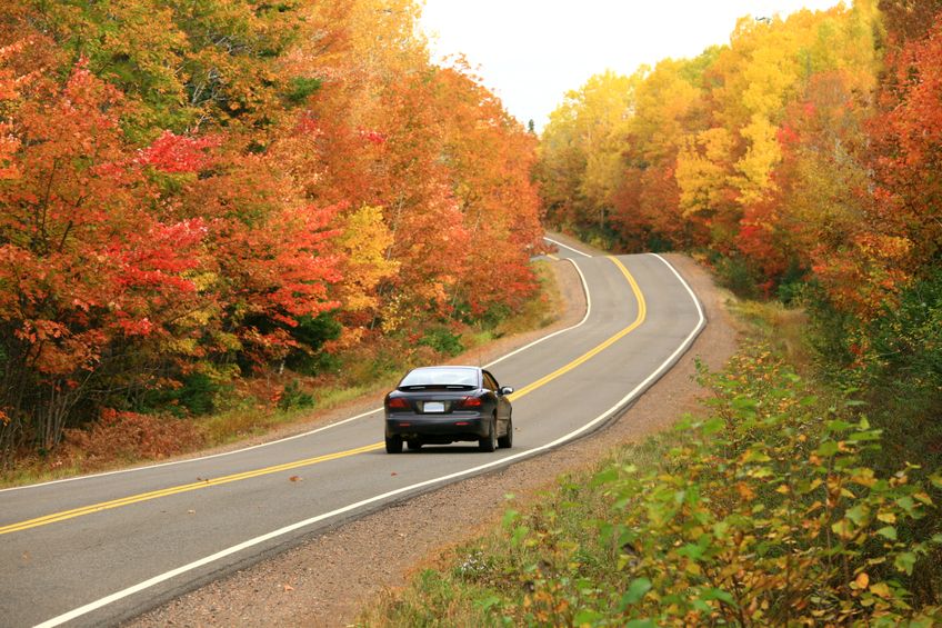 car driving down road in Fall