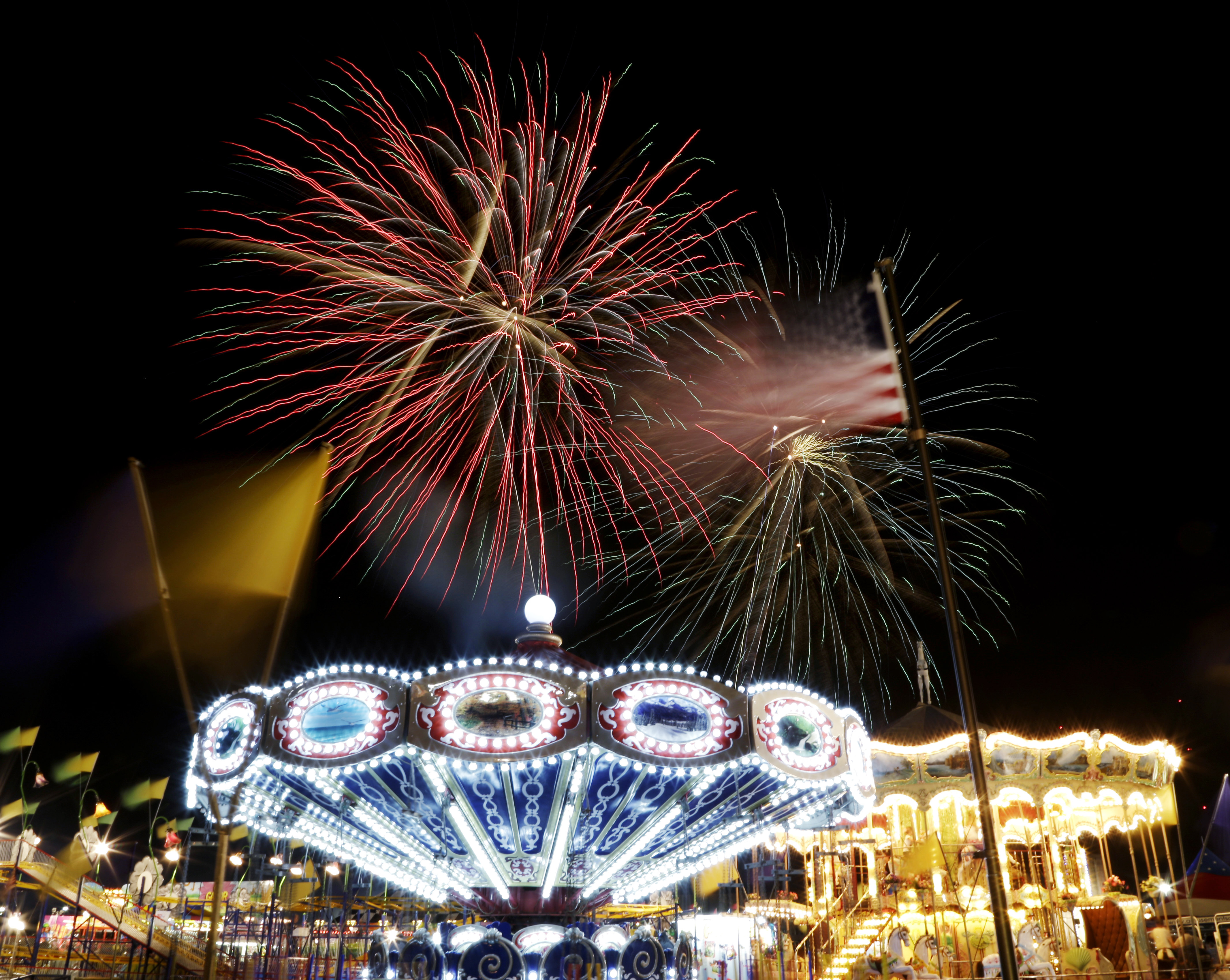 Carnival rides and fireworks at a county fair