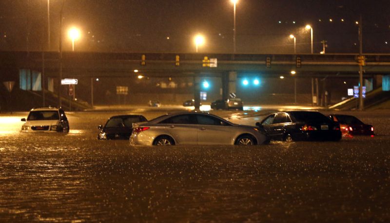 Cars sit submerged in flood waters on Tallapoosa Street