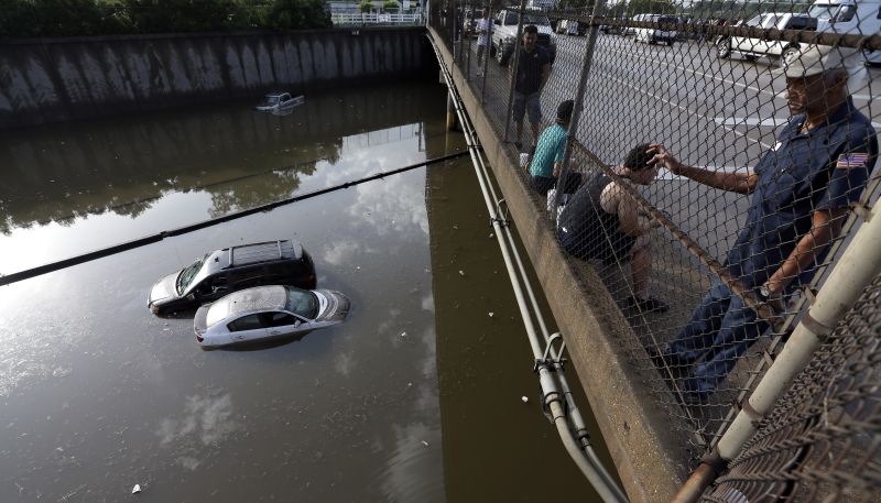 cars sit in floodwaters along Interstate 45
