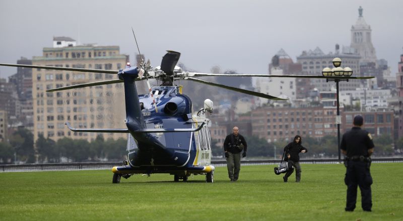 Emergency officials arrive by helicopter at Pier A Park near the Hoboken Terminal following a train crash
