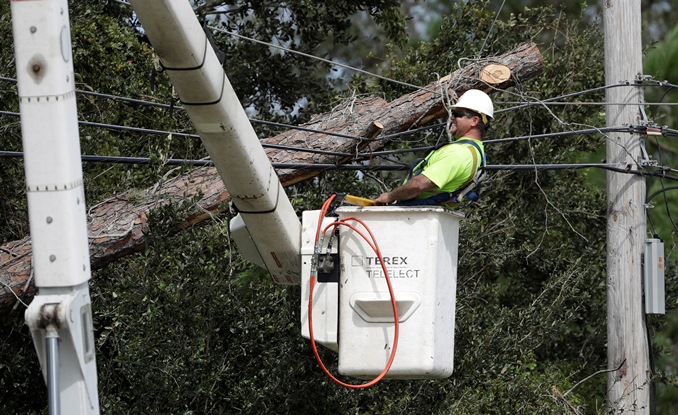 Lineman removing trees from power lines Hurricane Matthew