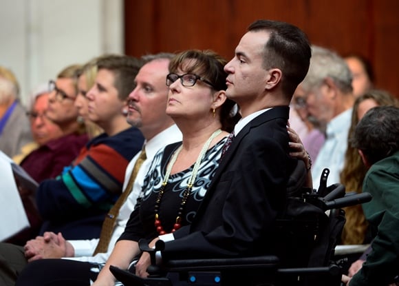 Paraplegic man in wheelchair in courtroom