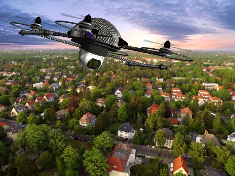 Drone quadrocopter with camera in flight over over suburban Houses