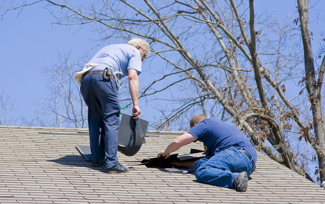 Men repairing roof after windstorm