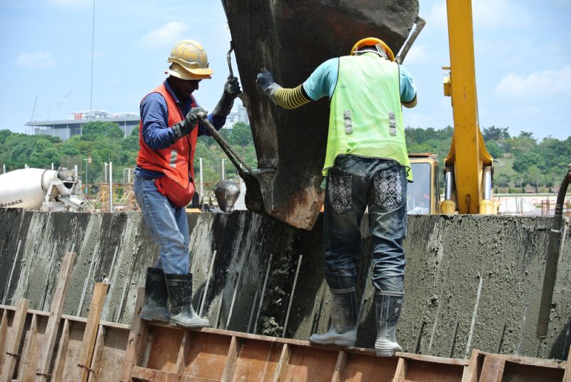 Construction workers with large city infrastructure equipment