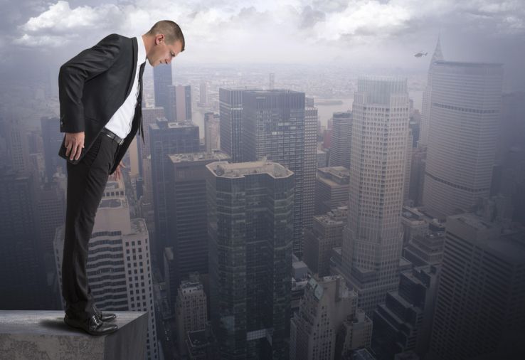 businessman look off ledge of building