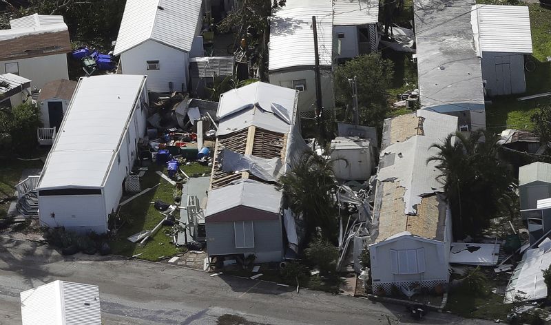 Roofs in a mobile home park are damaged from Hurricane Irma