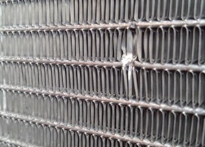 High winds send large debris flying and damaged this microchannel coil 