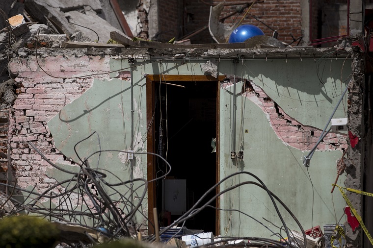 The doorway of a house collapsed by a 7.1-magnitude earthquake stands in San Gregorio Atlapulco, Mexico, Friday, Sept. 22, 2017. Authorities say 121 of the village's houses were severely damaged by the Tuesday quake and inhabitants are without water and electricity. The bell tower of the local church was toppled by the force of the quake. (AP Photo/Moises Castillo)