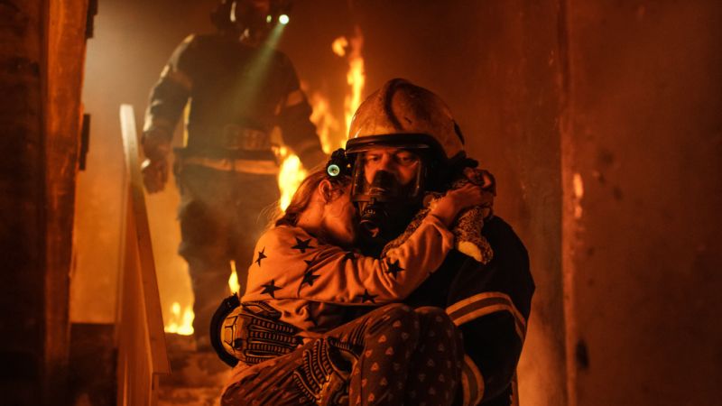 fireman rescuing child from burning home
