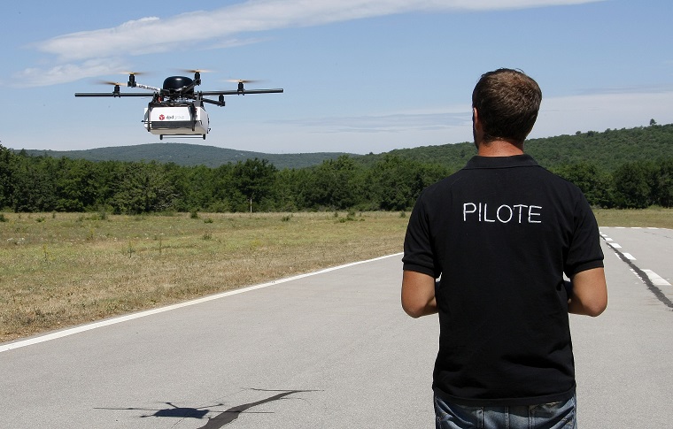 Benoit Leroux, drone pilot at DPD Geopost in France, demonstrates the use of a package delivery drone. GeoDrone completed its first successful automated package delivery flight more than two years ago. (AP Photo/Claude Paris)