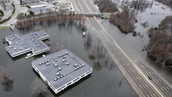 Commercial buildings underwater during Superstorm Sandy. (AP Photo/Charles Krupa)