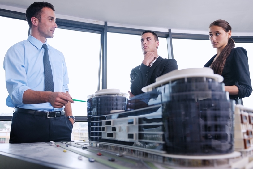 Architects-with-scale-model-of-building-in-office-shutterstock_153564098-dotshock
