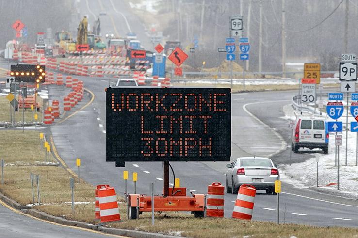 Highway construction work zone with snow